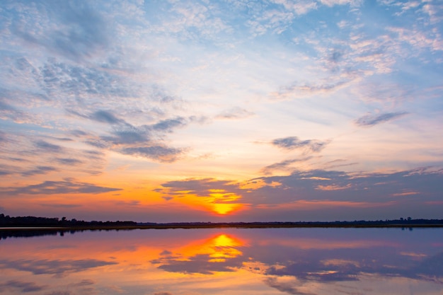 beautiful sunset behind the clouds and blue sky above the over lagoon 