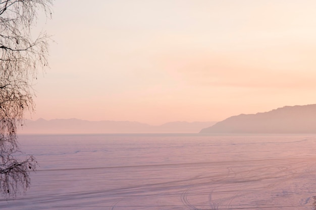 Beautiful sunset on frozen lake baikal winter landscape