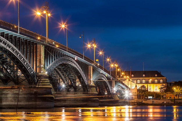 Beautiful sunset night over rhine / rhein river and old bridge in mainz near frankfurt am main, germany.