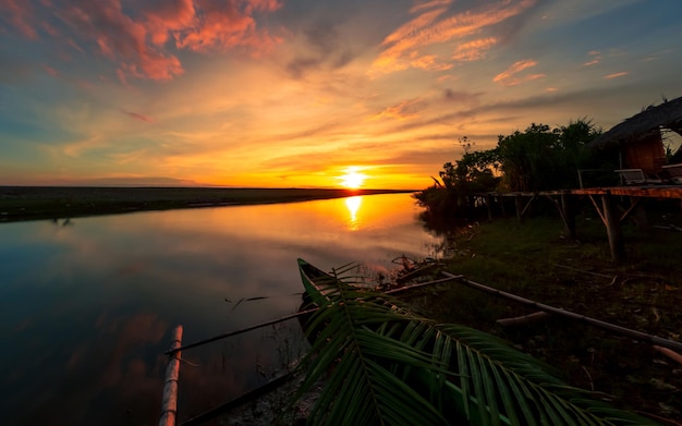 Beautiful sunset at riverside with boat