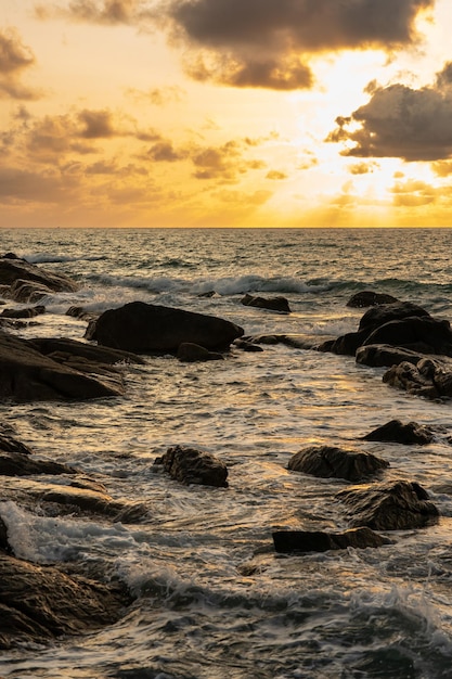 A beautiful sunset on the rocky beach.