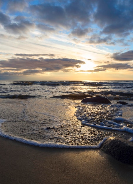 Beautiful sunset on the sandy beach of the Baltic Sea in Lietva Klaipeda