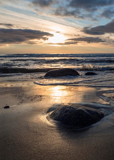 Beautiful sunset on the sandy beach of the Baltic Sea in Lietva Klaipeda