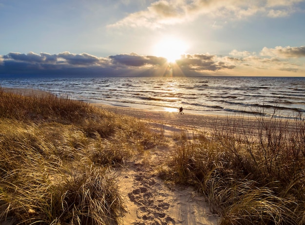 Beautiful sunset on the sandy beach and dunes of the Baltic Sea in Lithuania Klaipeda