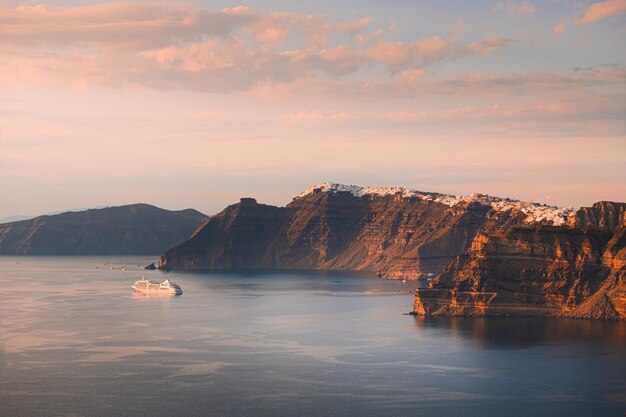 Beautiful sunset at Santorini island Greece Cruise ship near the coast