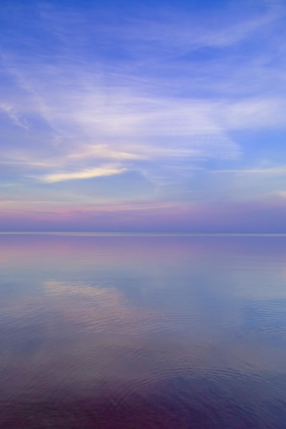 Beautiful sunset on sea pastel colors and reflections on water nature landscape with colorful clouds