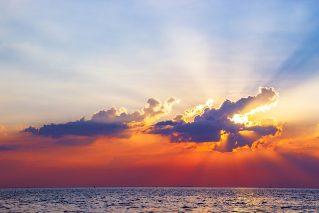 Beautiful sunset above the sea reflected on surface water colorful twilight.