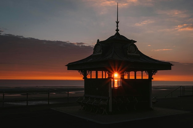 Beautiful sunset shining through a structure on the Blackpool shore