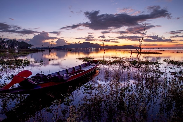 beautiful sunset sky and wood boat floating in bangpra 