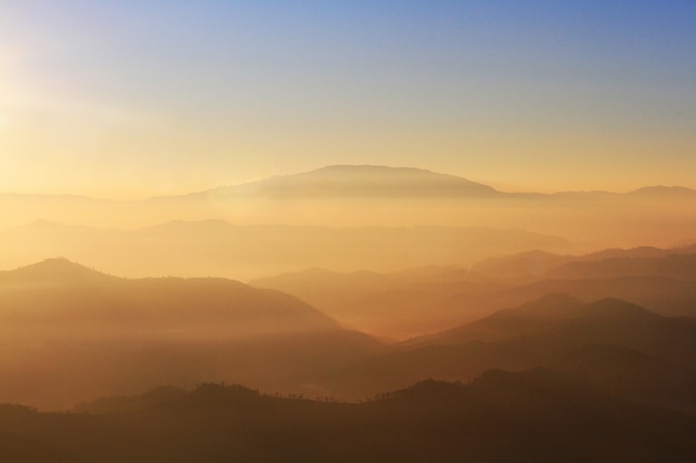 Beautiful Sunset and sunrise on sky and golden twilight time with mist and fog in valley of mountain layer