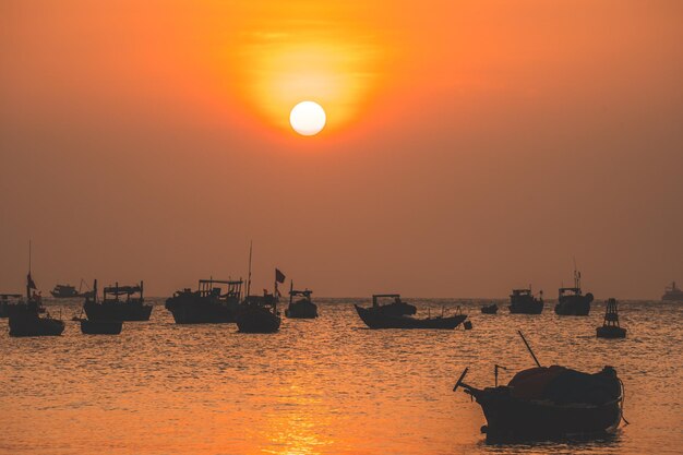 Beautiful sunset tropical beach with small boat and cinematic sky for travel and vacation in holiday