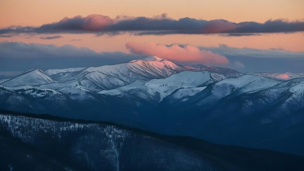 Beautiful sunset view with snow covered mountains and clouds as viewed from mount evans in colorado