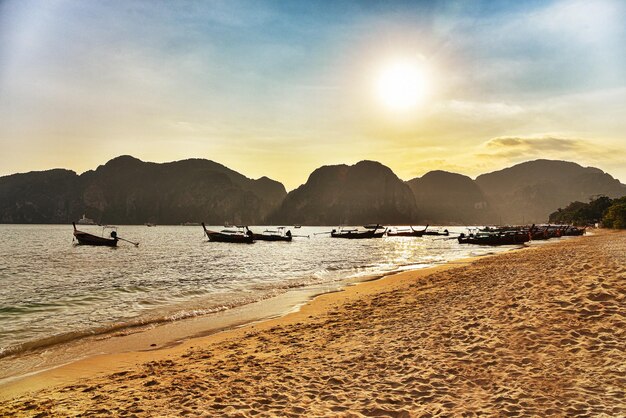 Beautiful sunset with fishing boat in Thailand Tropical island in Asian sea