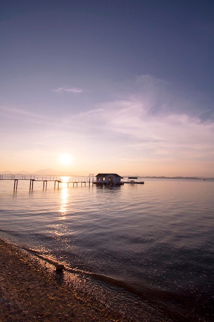 Beautiful sunset with Wooden bridge over the sea in sacheon city Korea