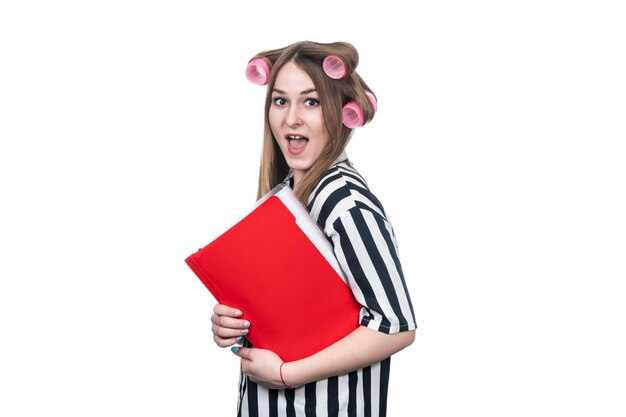 beautiful surprised business woman in hair rollers with a folder in her hand isolated on white background