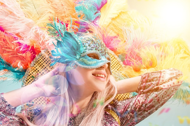 Beautiful surprised woman in carnival mask Beauty model woman wearing masquerade mask at party