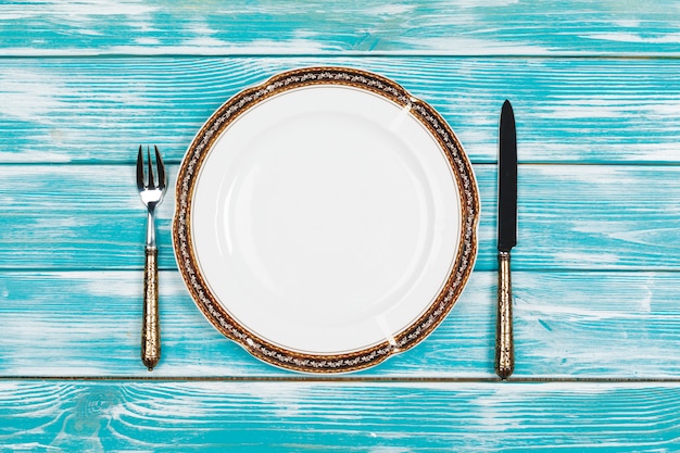 Beautiful table setting on blue wooden 