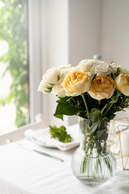 Beautiful table setting for romantic dinner for two roses bouquet copy space