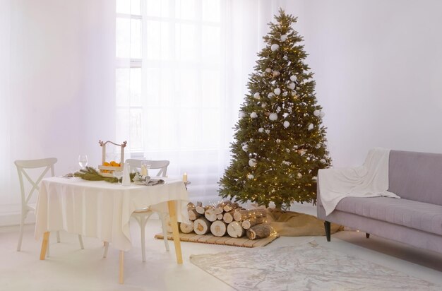 Beautiful table setting with Christmas decorations in big white living room. Dinner or lunch