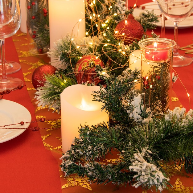 Beautiful table setting with Christmas decorations. Red colors