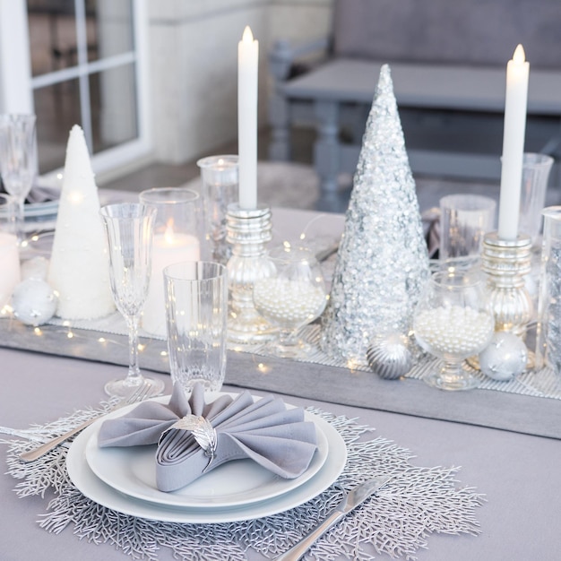 Beautiful table setting with Christmas decorations Silver colors