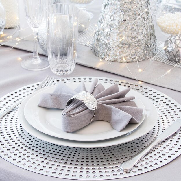 Beautiful table setting with Christmas decorations Silver colors