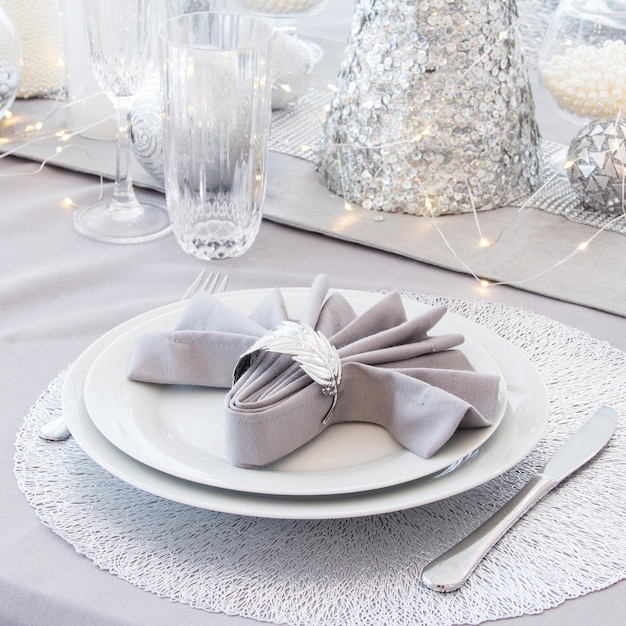 Beautiful table setting with Christmas decorations Silver colors