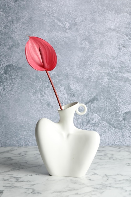 Beautiful tail flower in vase on marble table