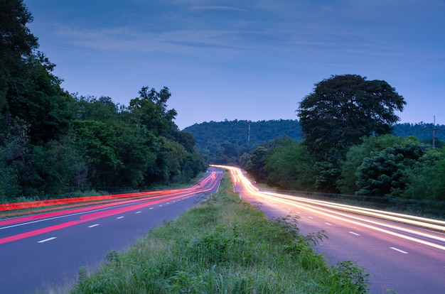 Beautiful Tail lights and head light of a cars pass on a country road hill 