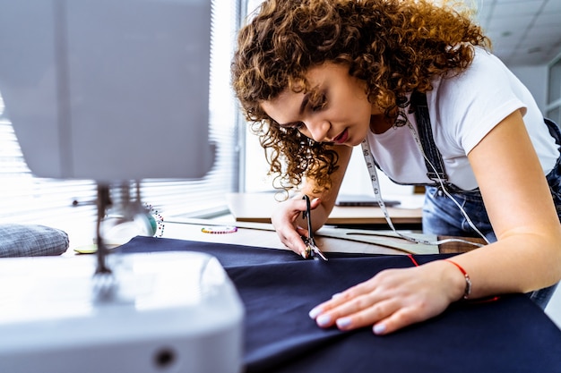 The beautiful tailor working on the table