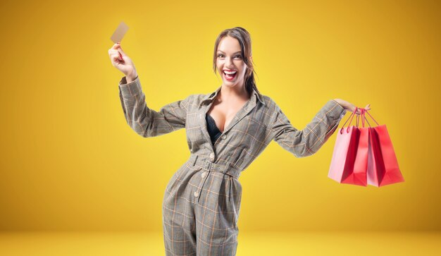 Beautiful tall woman with red packages in her hands