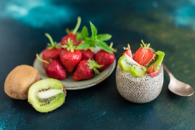 Beautiful and tasty dessert with a kiwi, strawberry and seeds of a chia