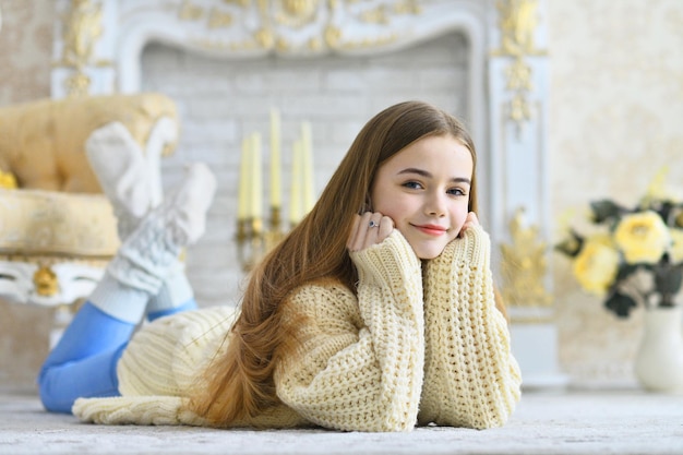 Beautiful teen girl lying on floor in room