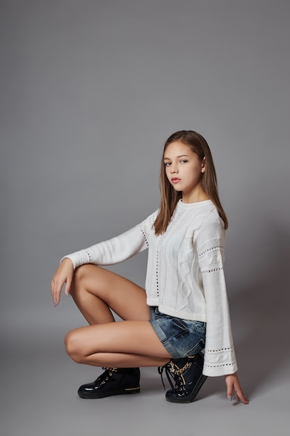 Beautiful teen girl smiling sitting on floor