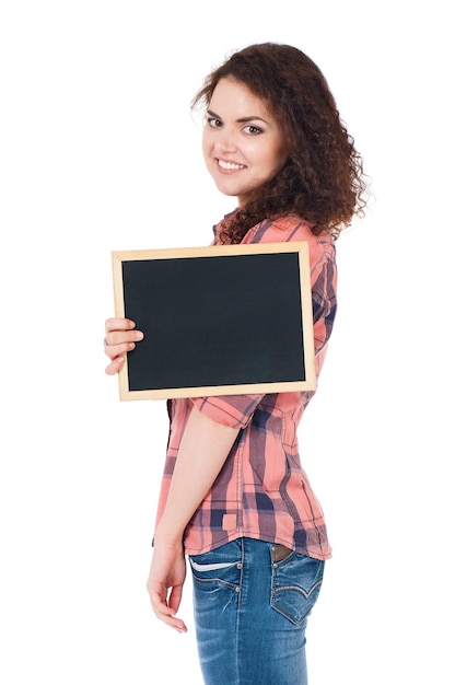 Beautiful teen girl with small blackboard posing on white background