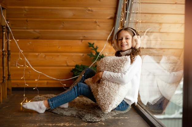 beautiful teenage girl at home near the window