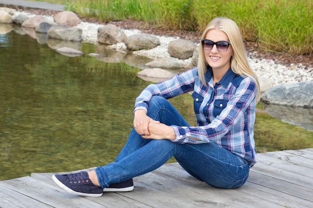 Beautiful teenage girl sitting in park