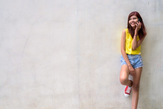 Beautiful teenager girl wearing vibrant yellow shirt