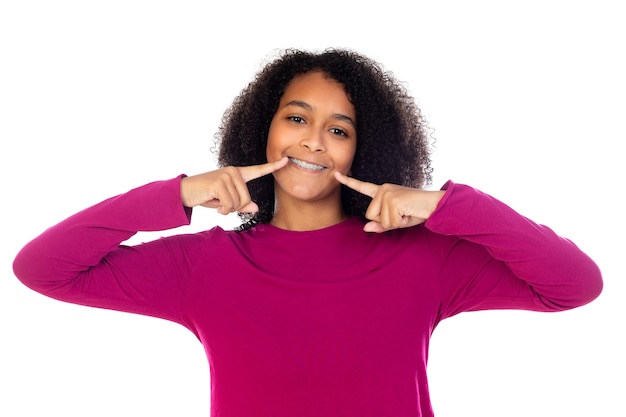 Beautiful teenager girl with dental braces isolated on a white wall