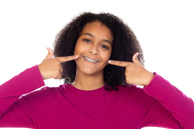 Beautiful teenager girl with dental braces isolated on a white wall