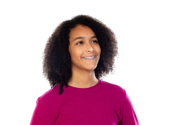 Beautiful teenager girl with pink sweater isolated on a white wall