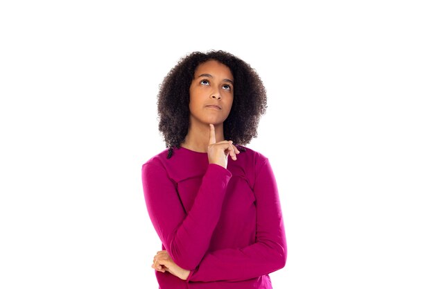 Beautiful teenager girl with pink sweater isolated on a white wall