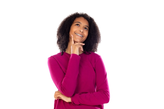 Beautiful teenager girl with pink sweater isolated on a white wall