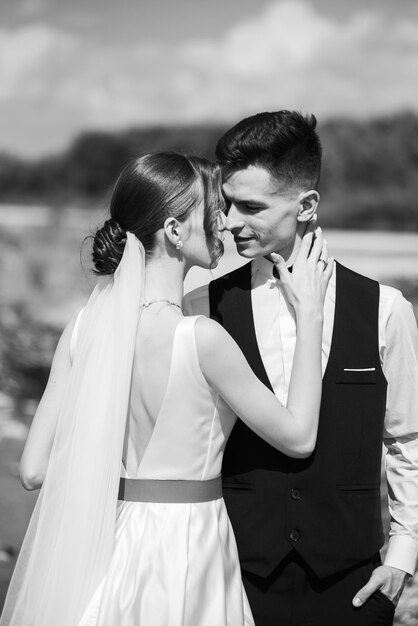 Beautiful tender young groom and wife Black and white photo