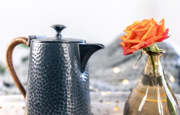 Beautiful textural teapot on a blurred background in a cozy home interior