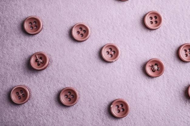 Photo beautiful texture with many round pink buttons for sewing needlework copy space flat lay pink