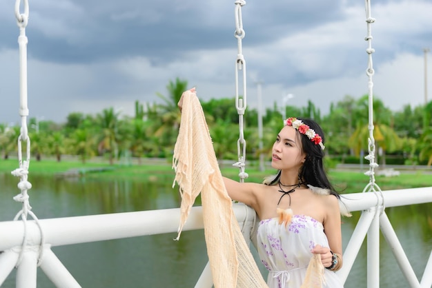 Beautiful thai woman Sit on the bridgeasian girl in bohemian stylehippie girl concept