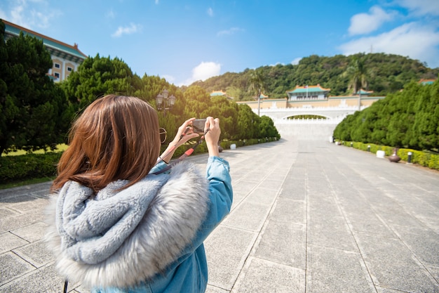 Beautiful tourist woman is photographing  in a famous place Taipei, Taiwan 