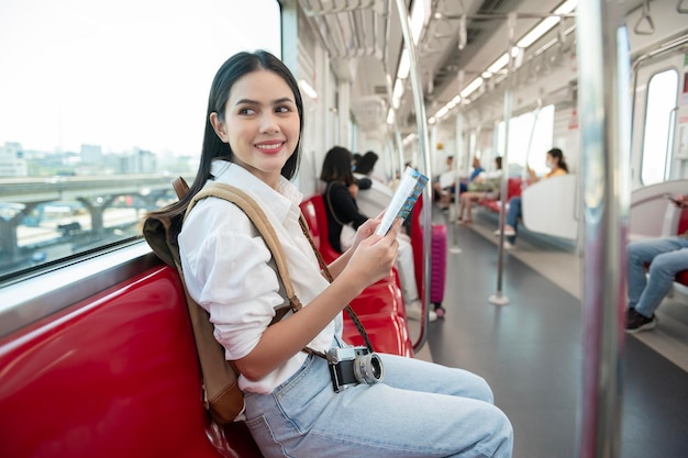 Beautiful tourist woman on vacation traveling on the subway train Holidays concept