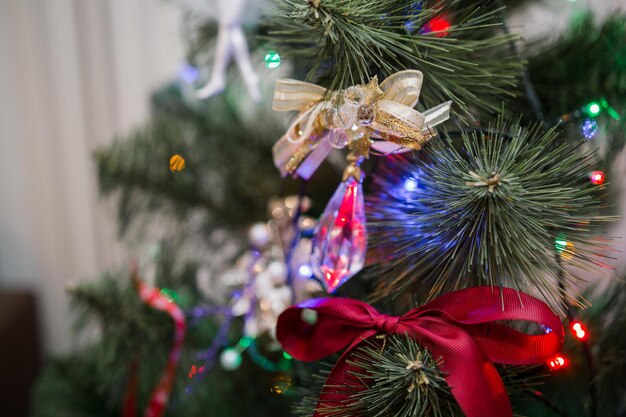 Beautiful toys on the christmas tree with garland